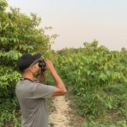 Pittachhara land owner (Mahfuz Russel) using Oriental Bird Club donated binoculars to monitor local biodiversity